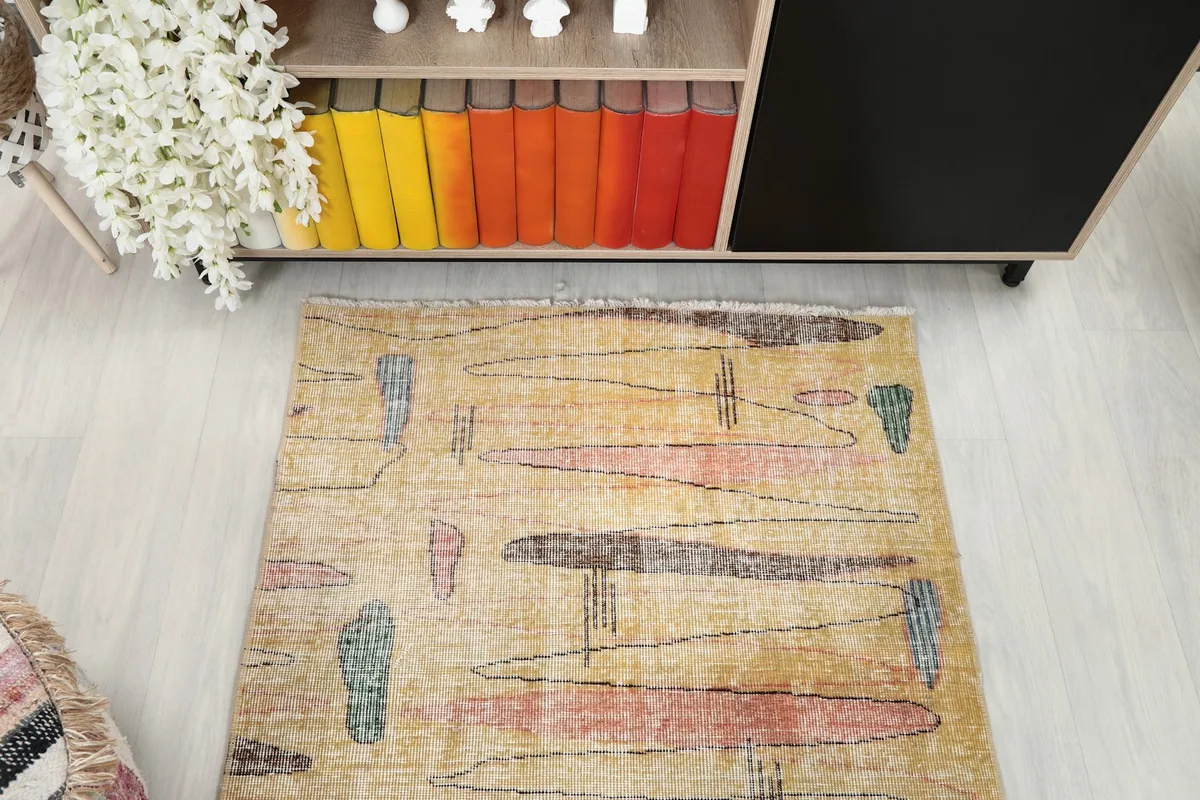 Overhead shot of the rug's central design and color variations, showing its vintage character