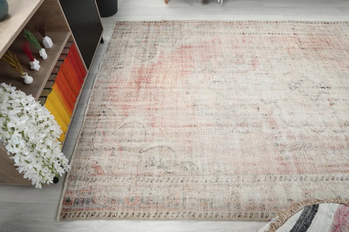 Corner view of the rug on the floor, showing its edges and the blend of colors.