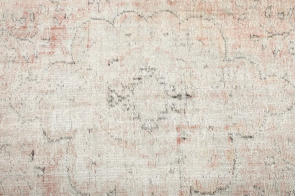 Detailed view of the central area, showing the distressed pile and visible geometric designs.