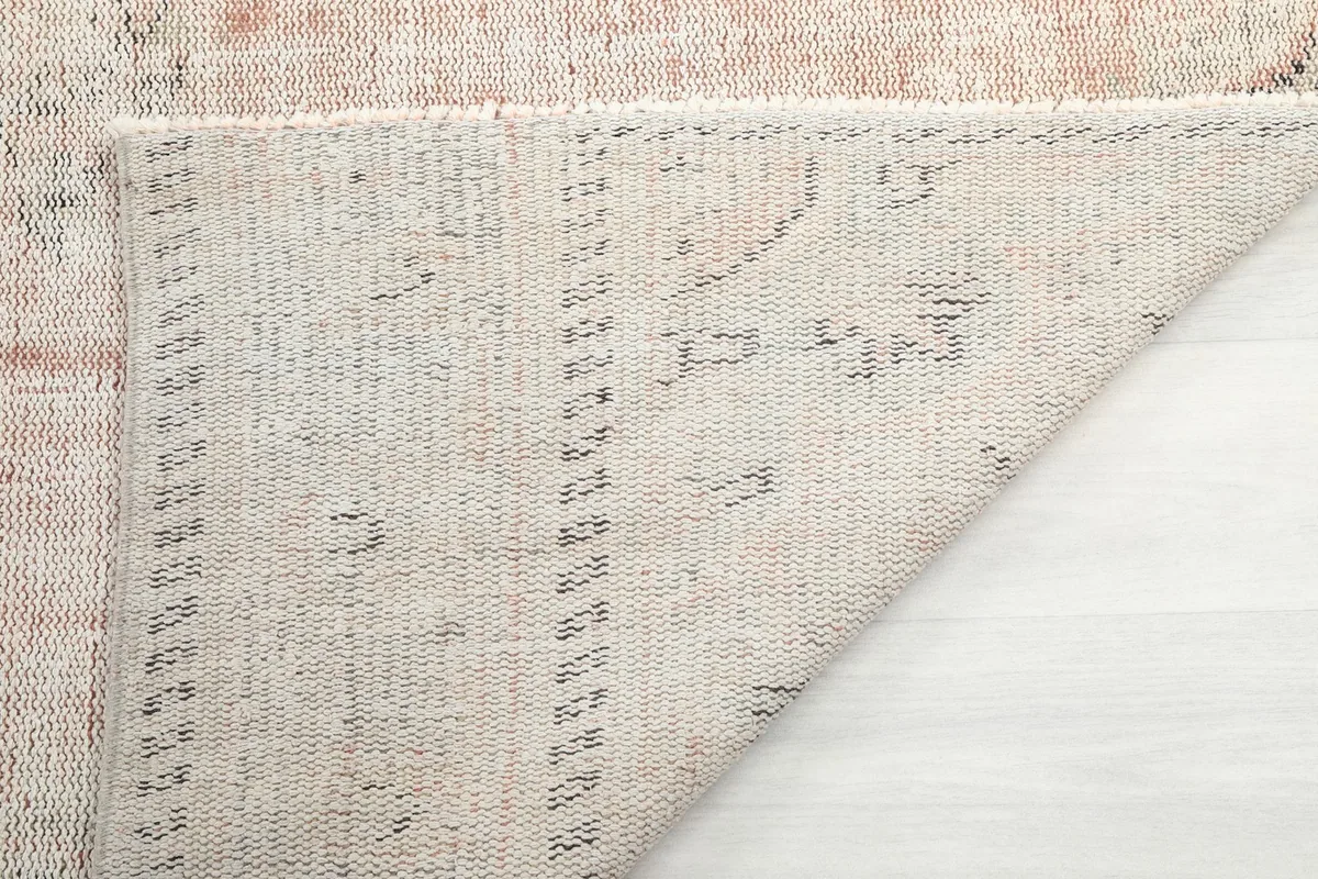 Underside view of the rug, showing the hand-knotted cotton foundation and construction details.