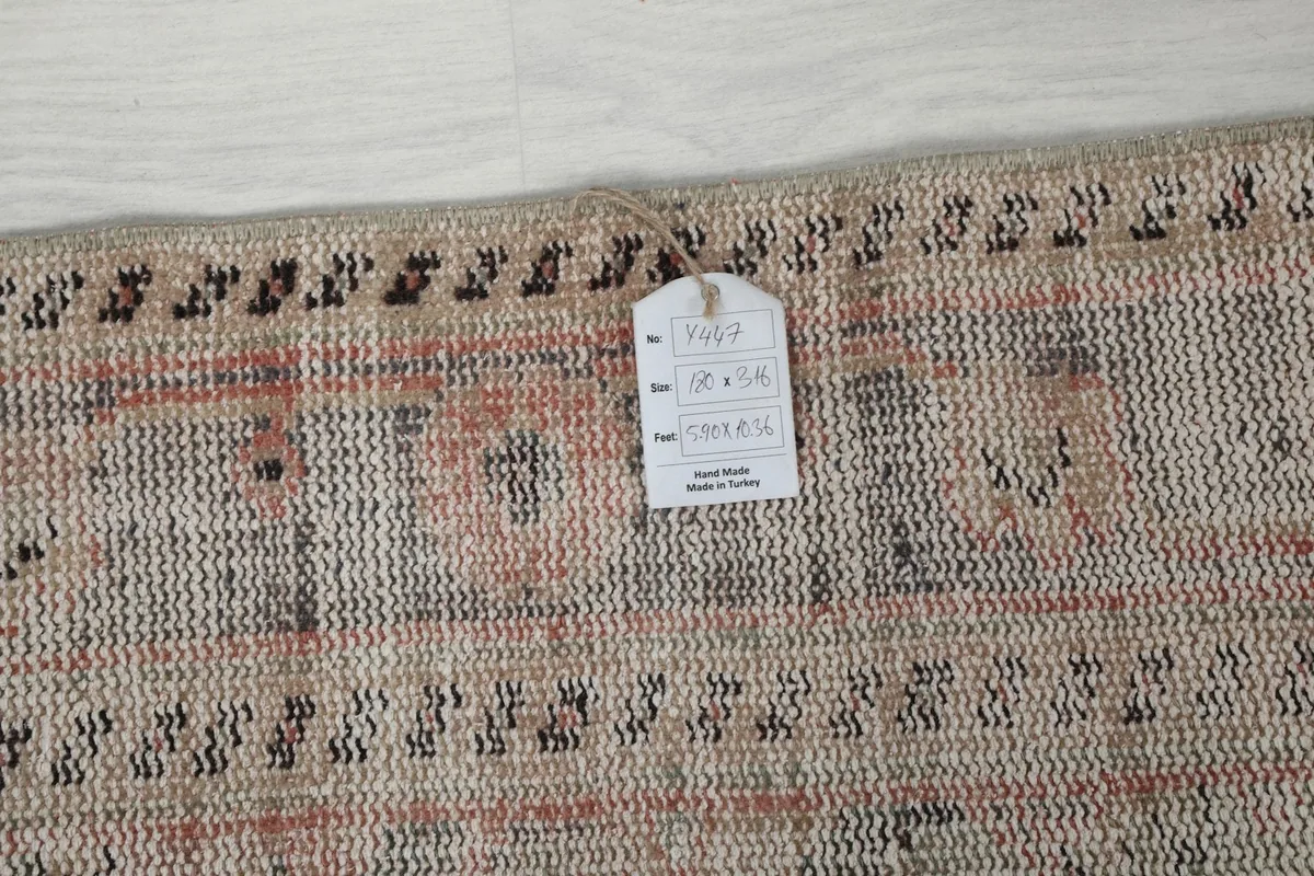 Close-up of the rug's edge with a product tag, indicating its origin and material.