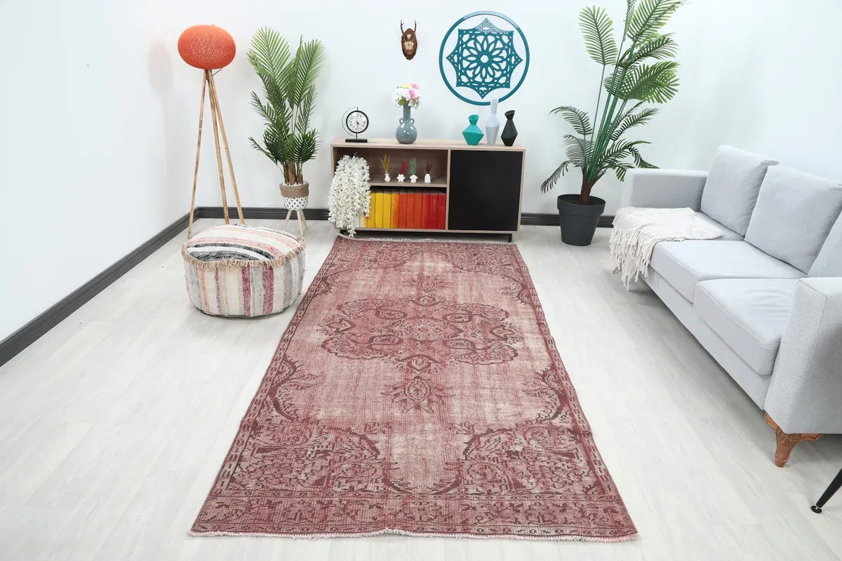 Vintage rose area rug in a modern living room setting with a light gray sofa