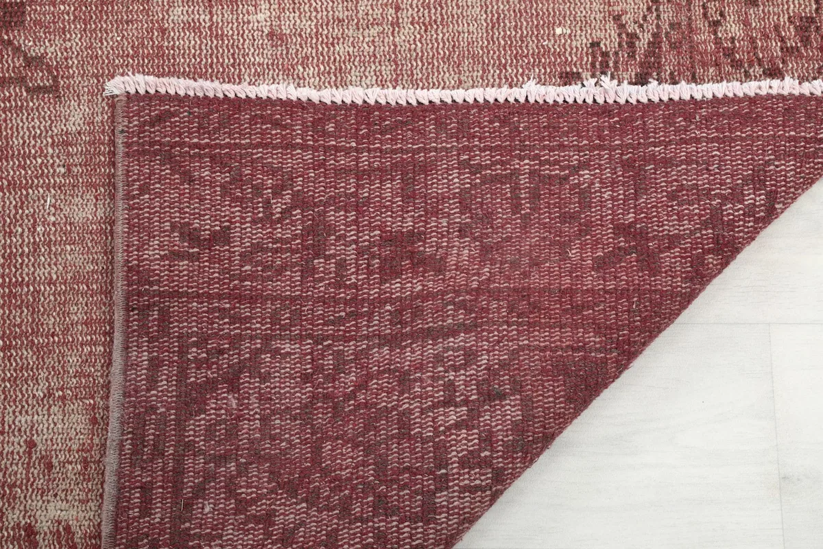 Underside of the rug showing the hand-knotted cotton foundation and tight weave