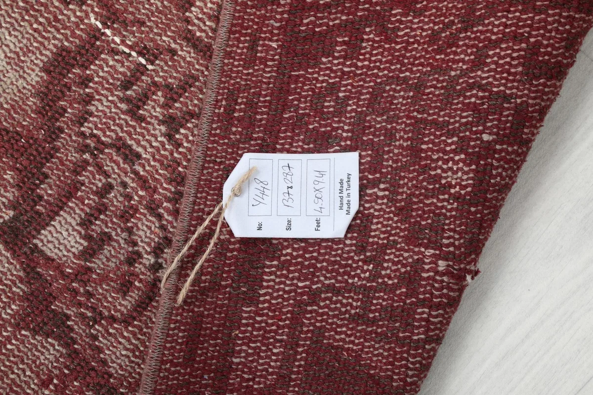 Rug label attached to the back, indicating its origin and material