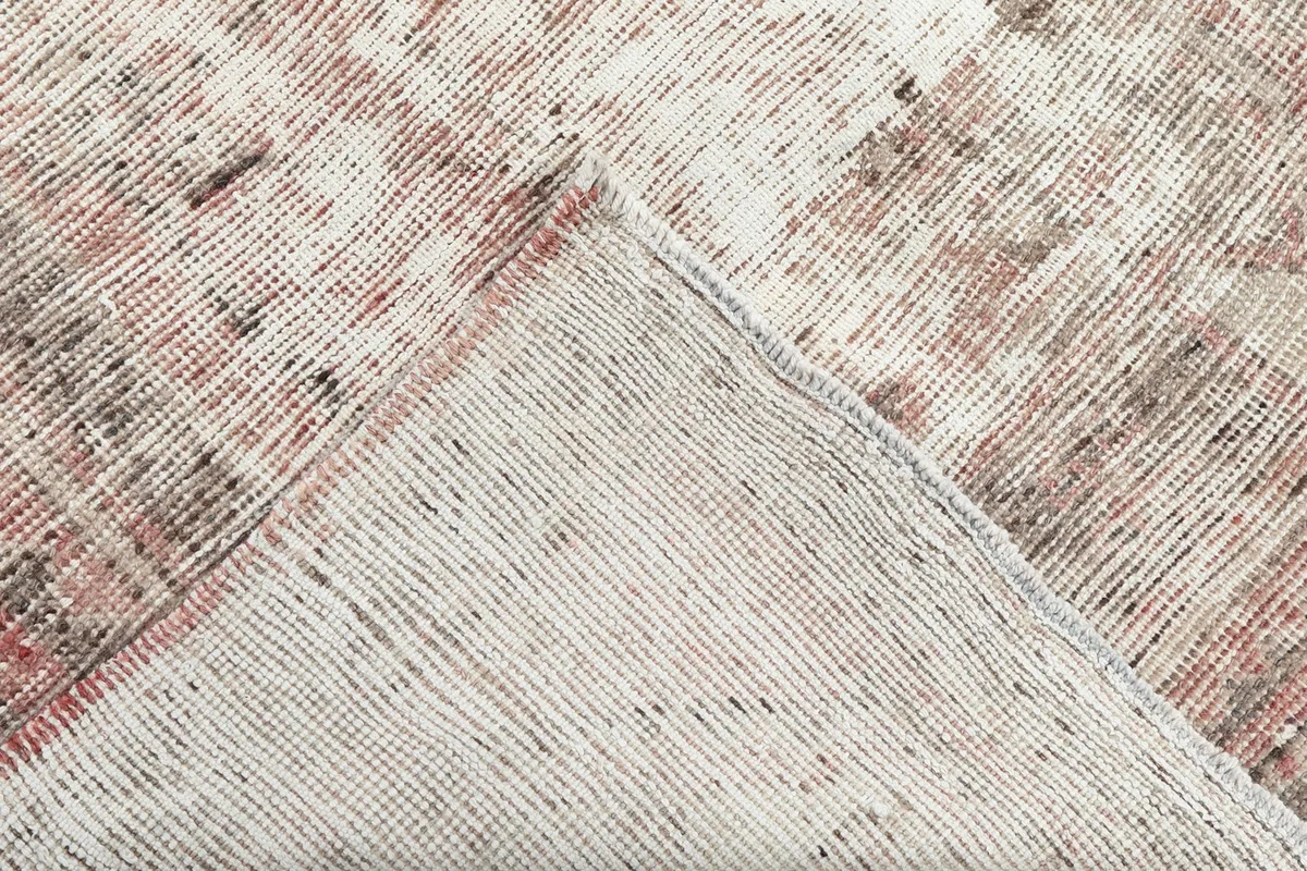 View of the back of the hand-knotted wool rug, showing the cotton foundation and tight weave