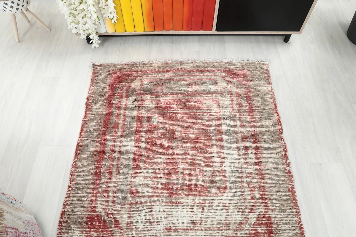 Overhead view showing a section of the runner rug and its overall distressed appearance