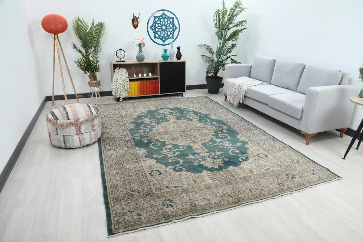 Angled view of the large blue and beige rug in a room, showing its scale with furniture