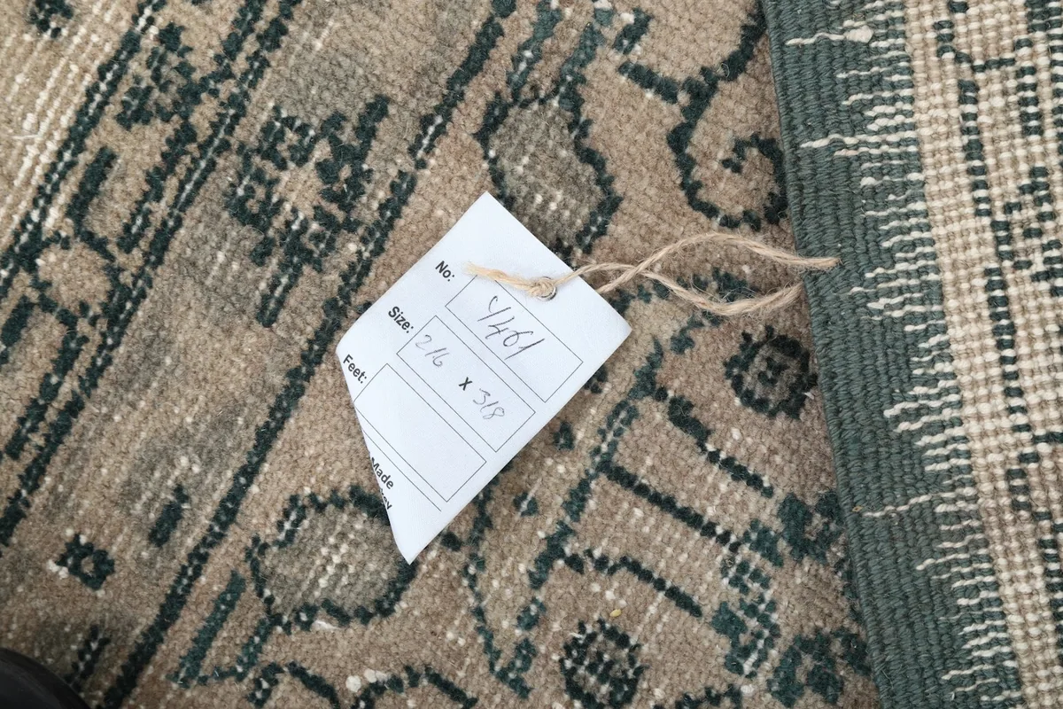 Tag displaying the rug's size (7'1" x 10'5") and item number on its reverse side