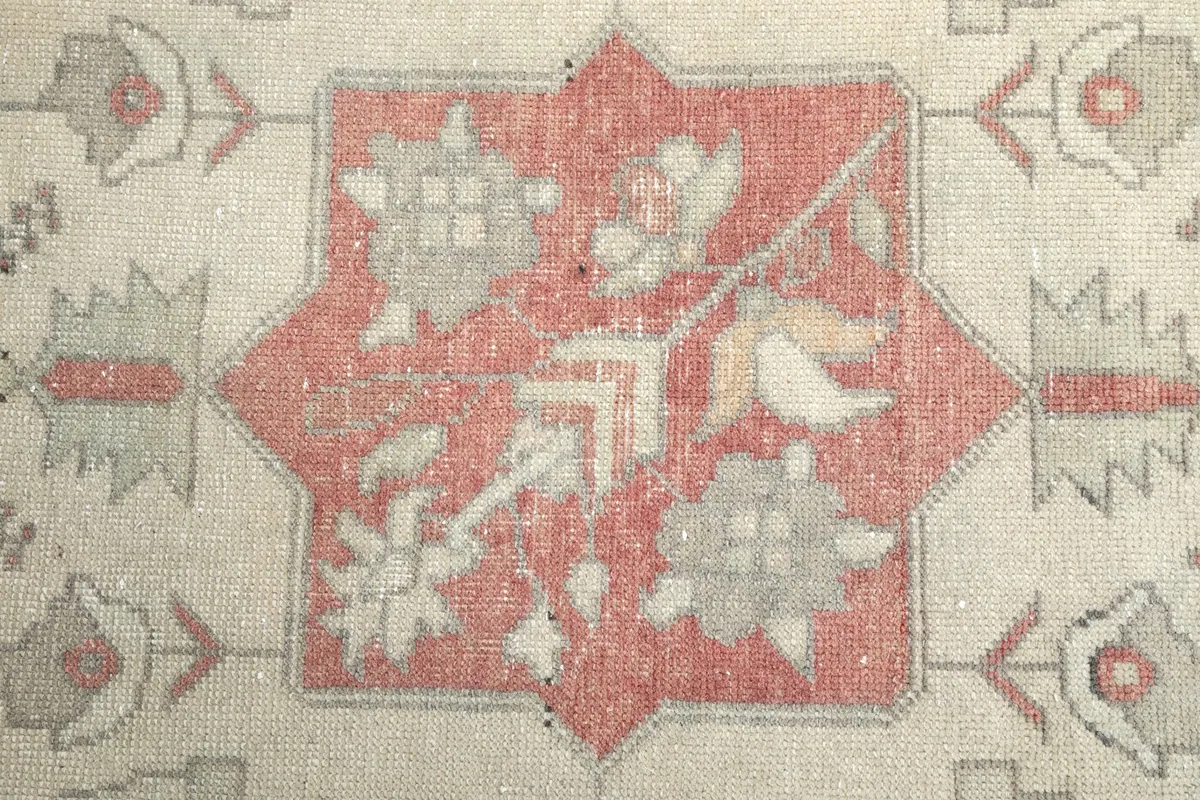 Close-up of the intricate floral and geometric patterns within the rug's medallion