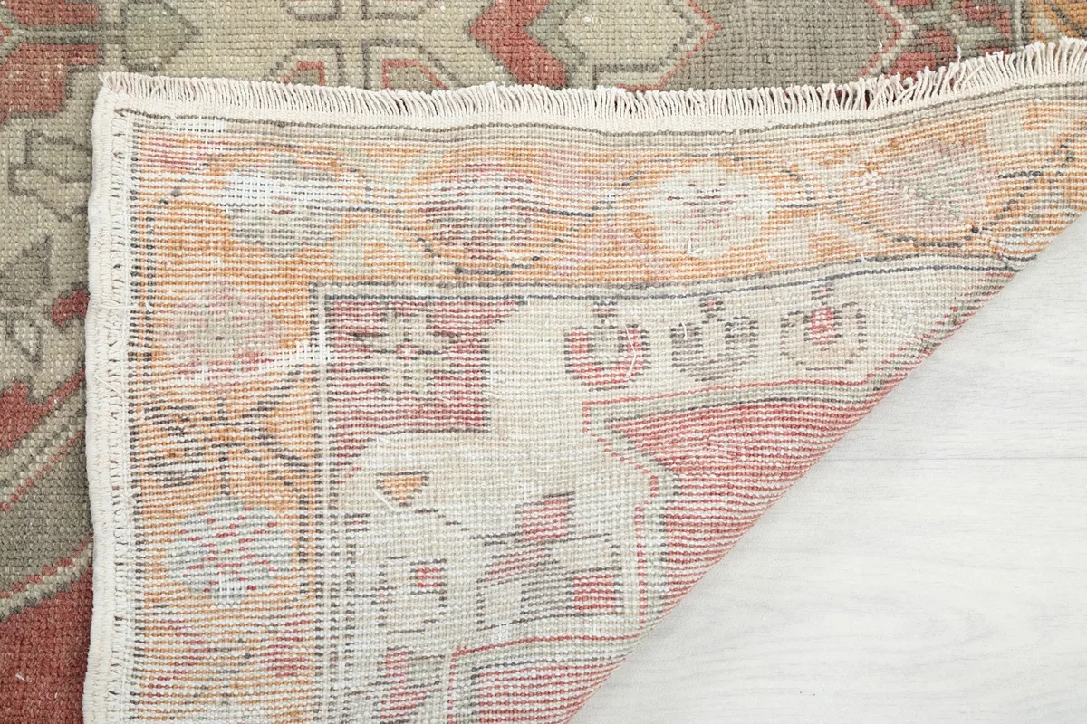 View of the rug's underside, showing the cotton foundation and knotting