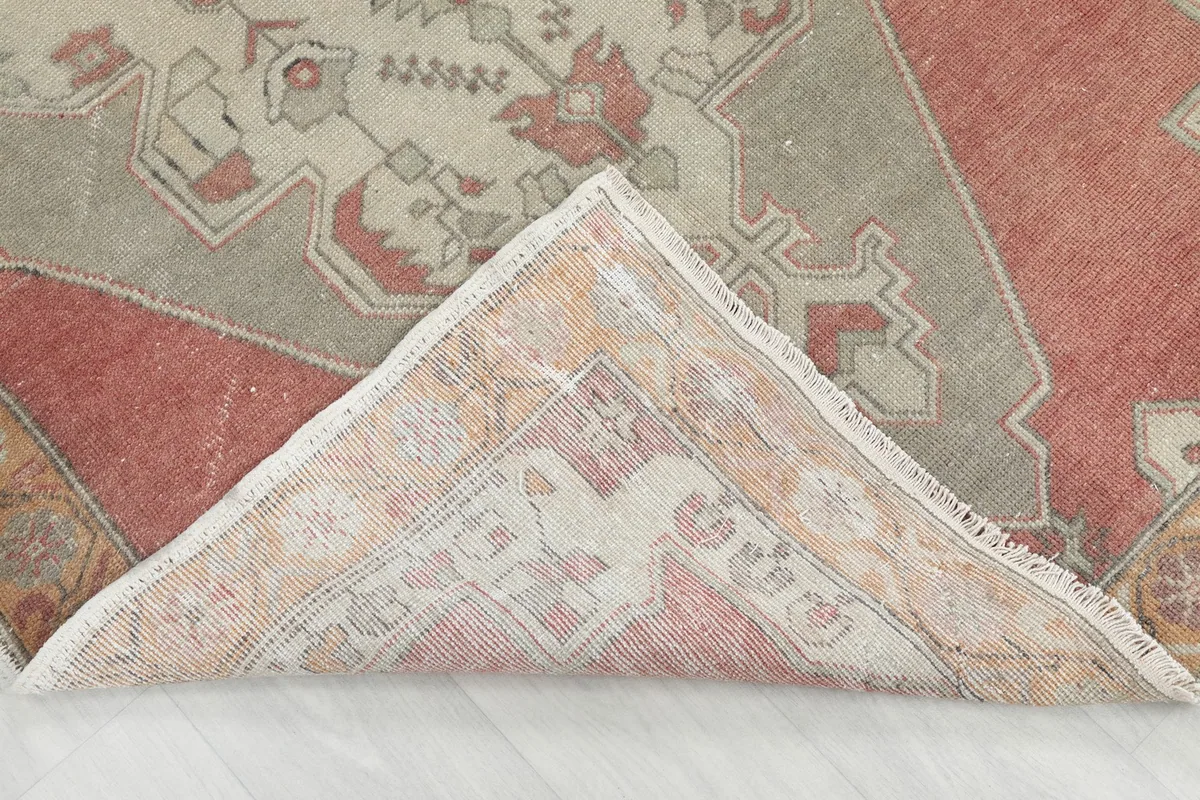 Folded corner of the rug revealing the back and the hand-knotted wool pile