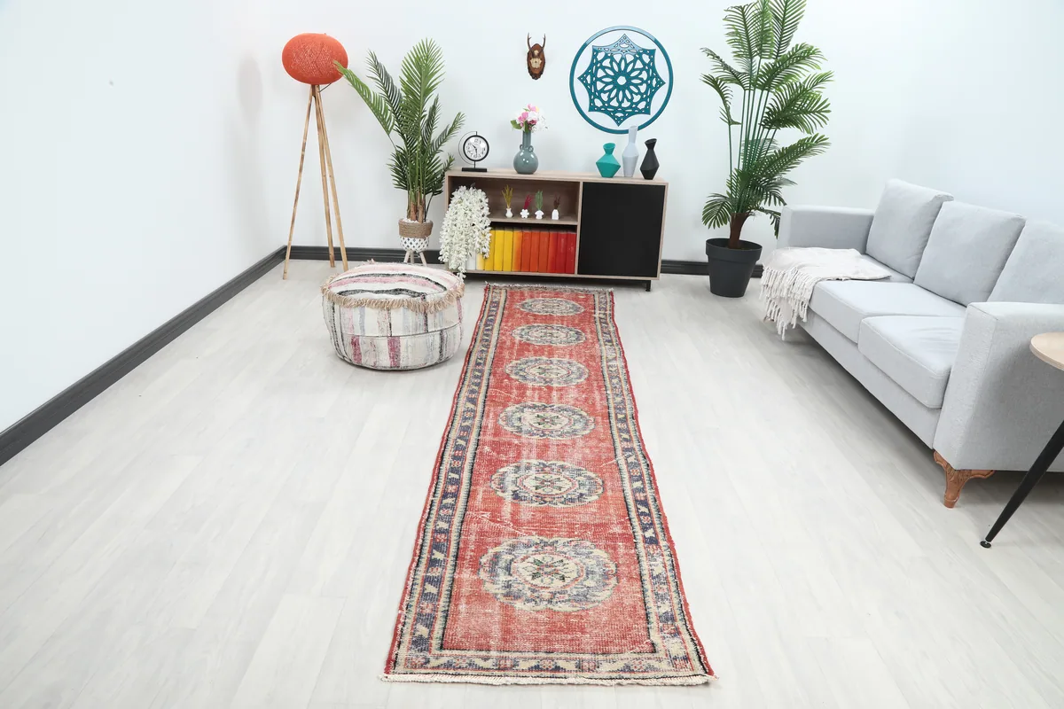 Faded Rust Medallion Anatolian Runner placed in a modern hallway setting, showing its length and colors.