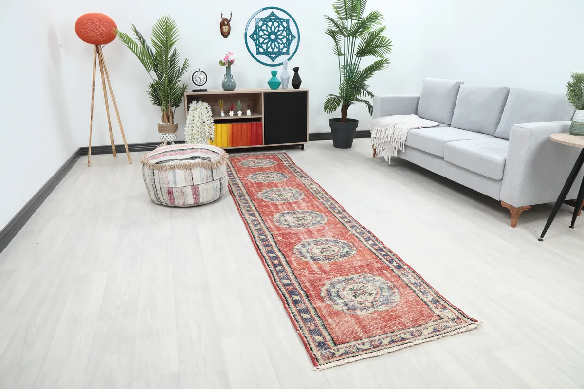 Angled view of the Faded Rust Medallion Anatolian Runner in a room, highlighting its design and how it fits the space.