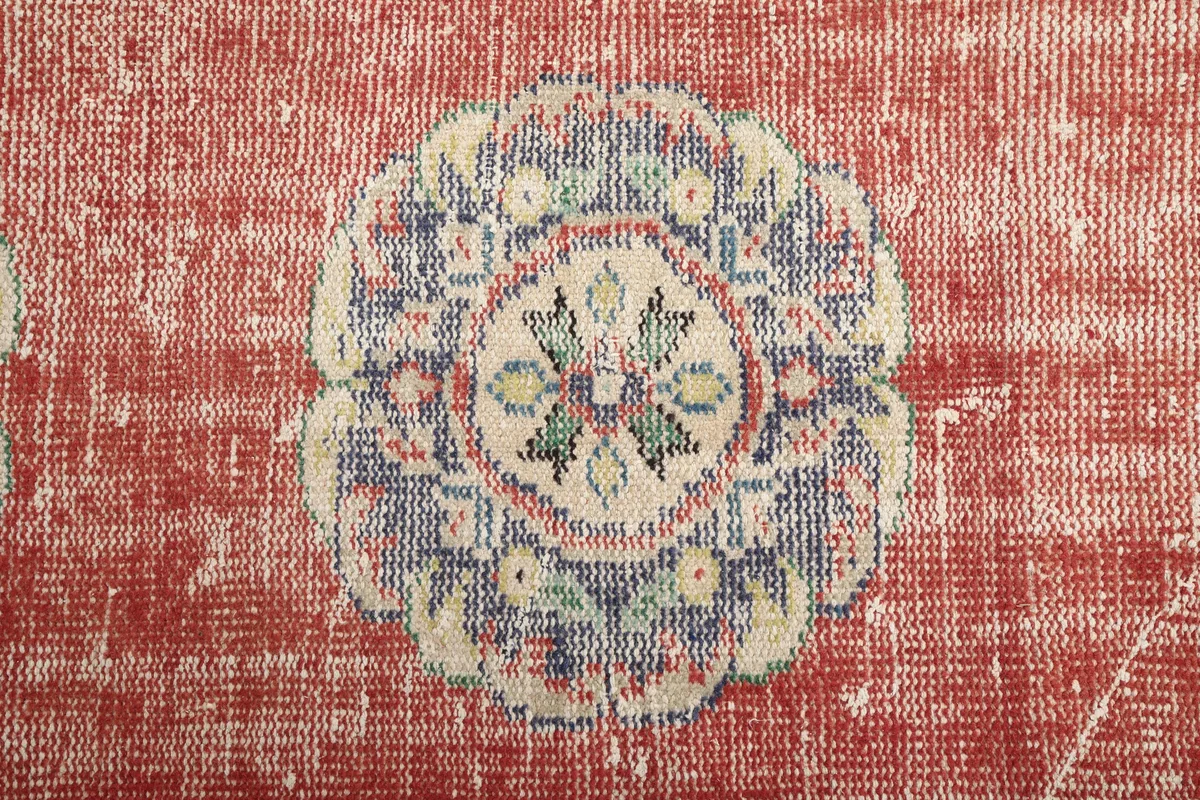 Close-up of a single medallion on the Faded Rust Medallion Anatolian Runner, showing the intricate details and colors.
