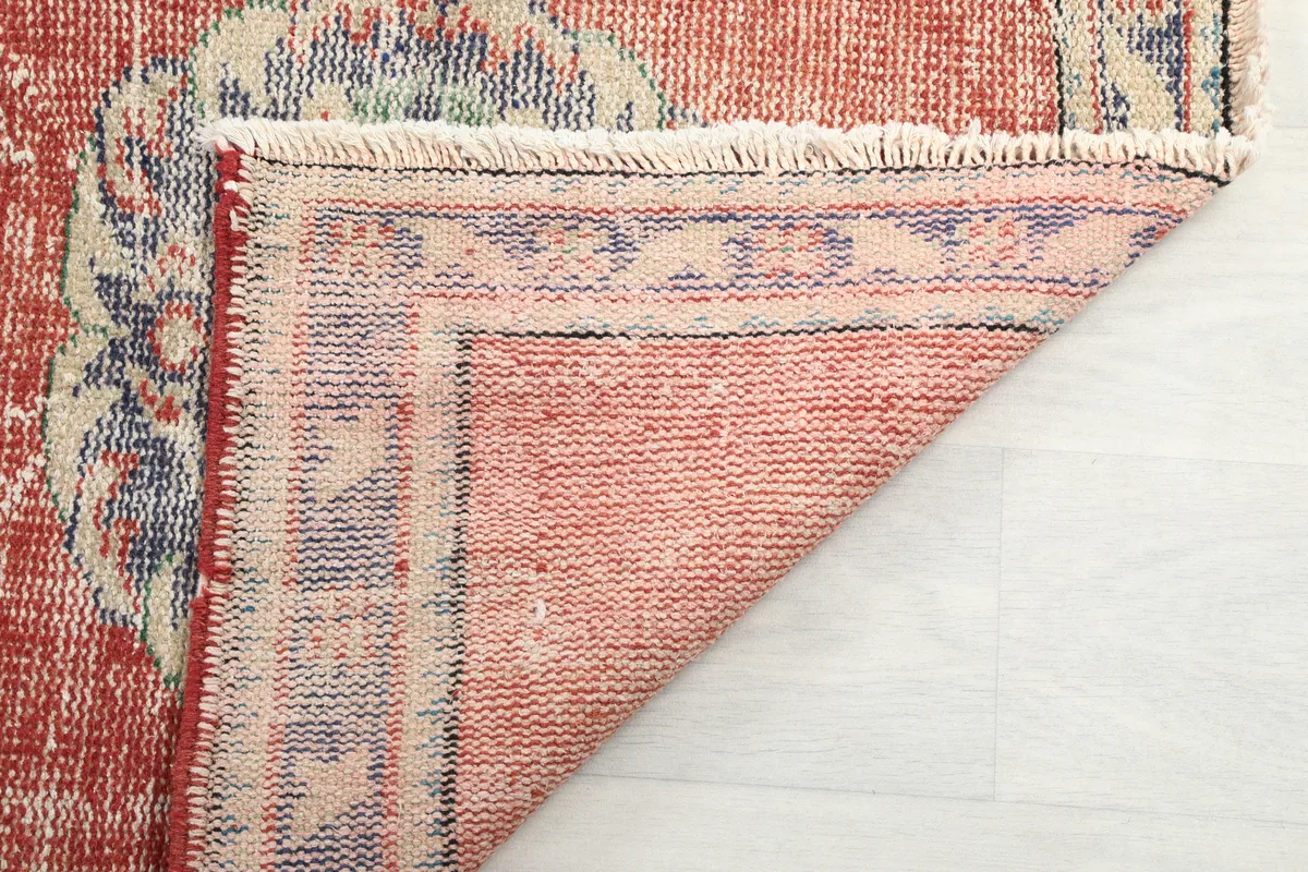 Close-up of the Faded Rust Medallion Anatolian Runner's back, showing the hand-knotted construction and cotton foundation.