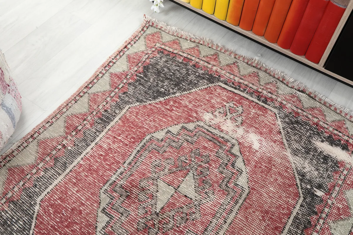 Overhead angle showing the texture and pattern of the vintage red and charcoal runner.