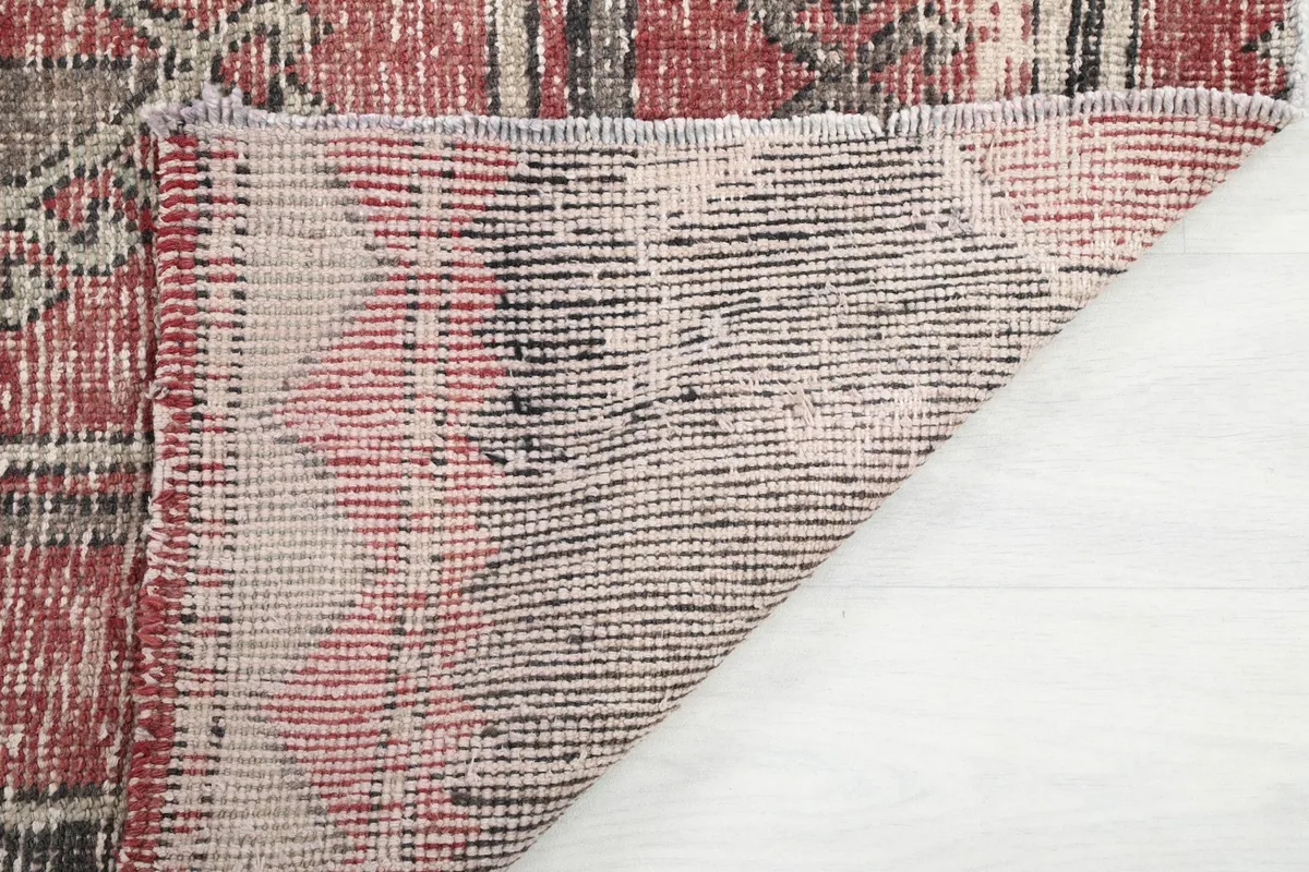 Close-up of the back of the hand-knotted rug, showing the cotton foundation.