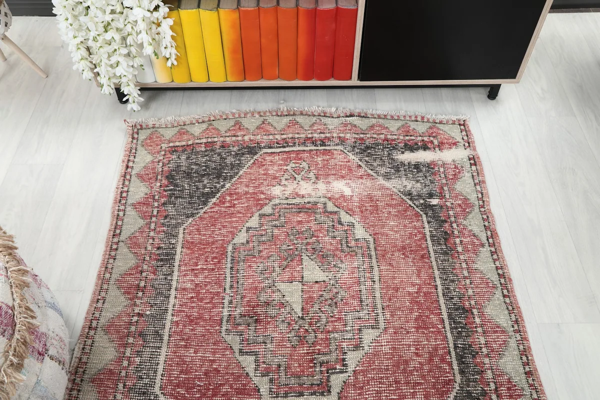 Overhead view of the red and charcoal runner, showing its full design and low pile.