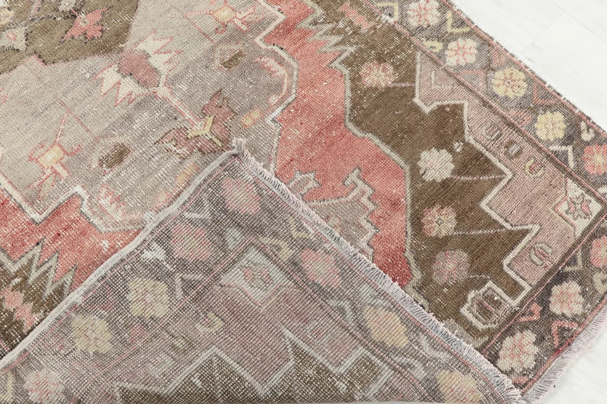 View of the back of the hand-knotted rug, revealing the cotton foundation and knotting structure.