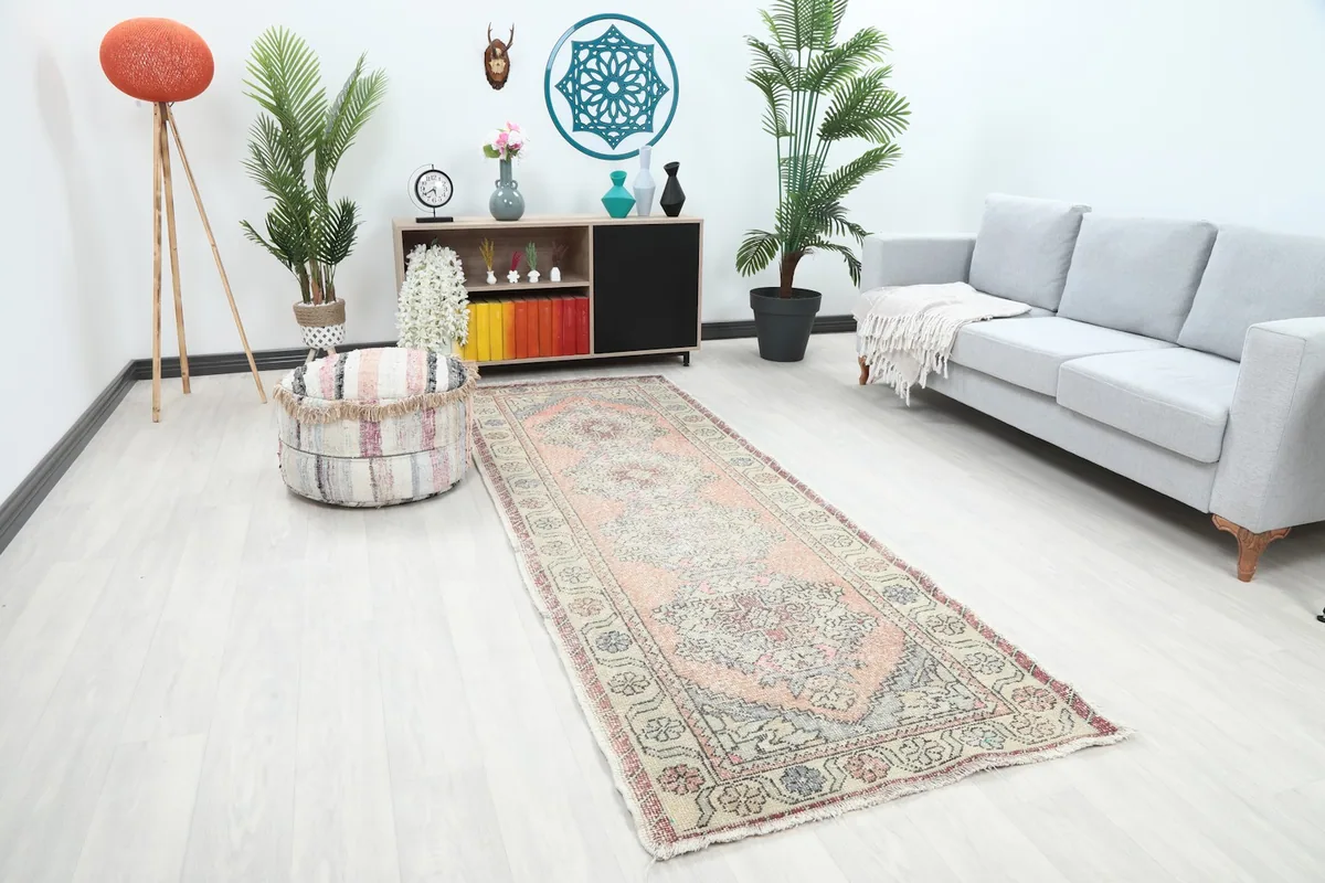 Angle view of the rust geometric Anatolian runner rug in a hallway setting, showing its length.