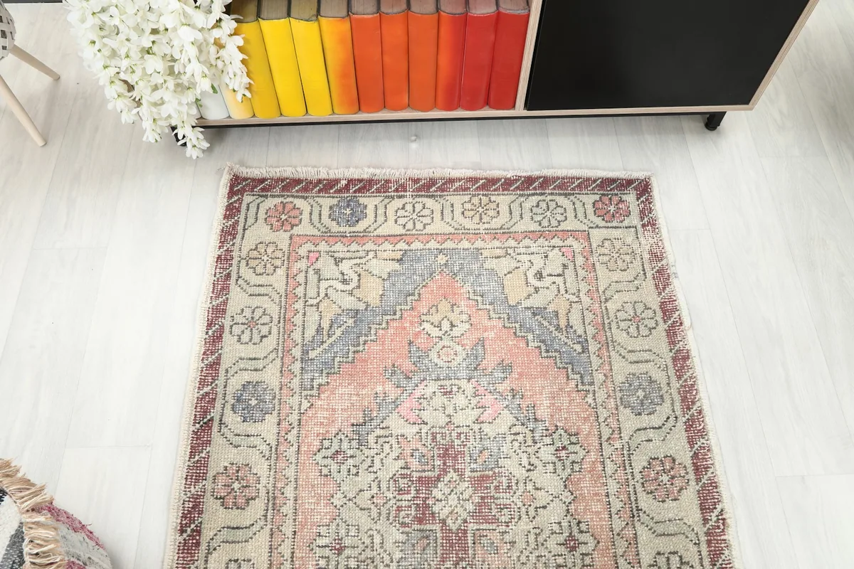 Overhead view of the rug's top portion, showcasing the repeating medallion and border design.