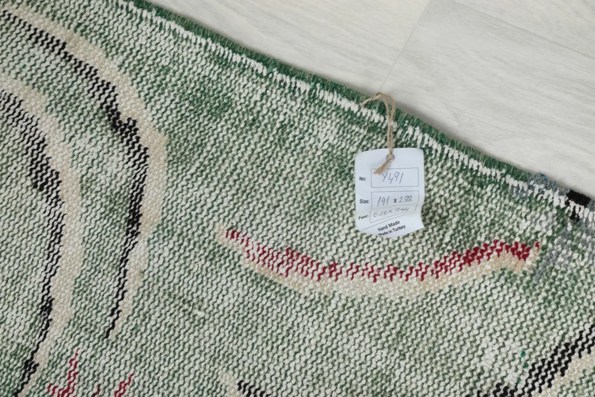 Close-up of the rug's back, revealing the product tag with size information and country of origin.