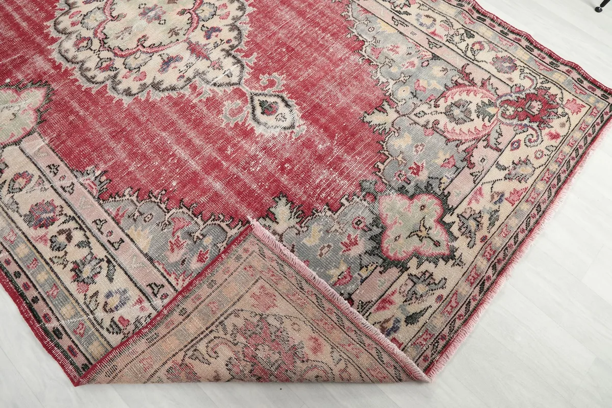 Folded corner of the rug revealing the thickness of the hand-knotted wool pile and cotton foundation