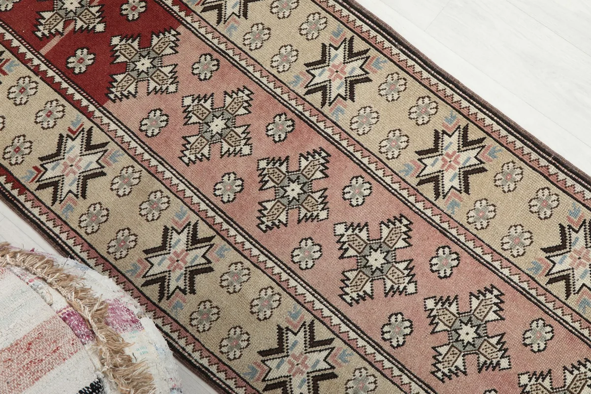 Angled view highlighting the transition from the red section to the pink and beige patterns.
