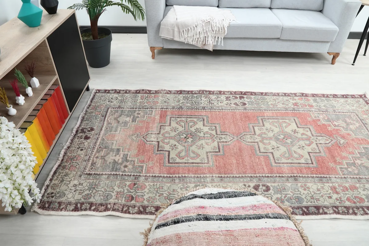 Wide shot of the rose geometric rug placed in a bright living room