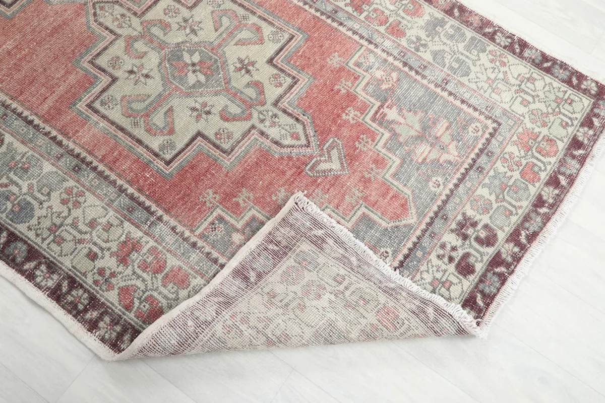 Corner of the rug folded back to show the reverse side and pile