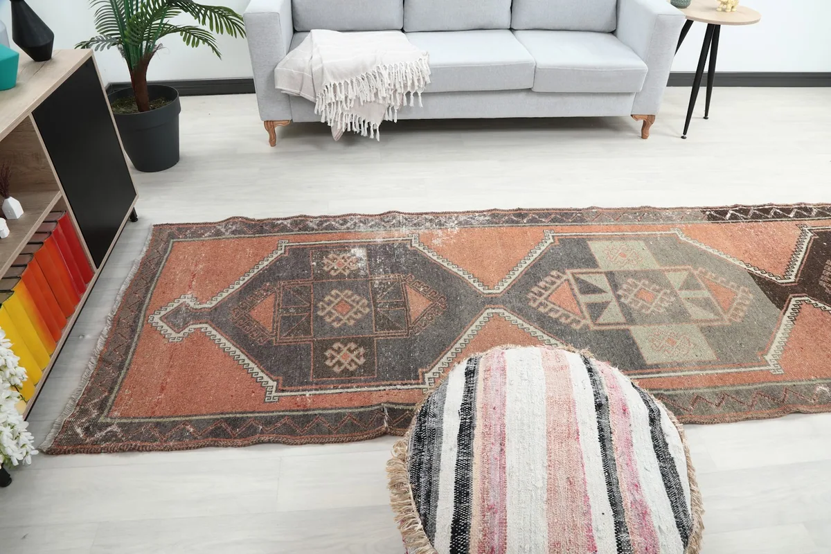 Full view of the runner rug in a living area, demonstrating its scale and vibrant colors against light flooring.
