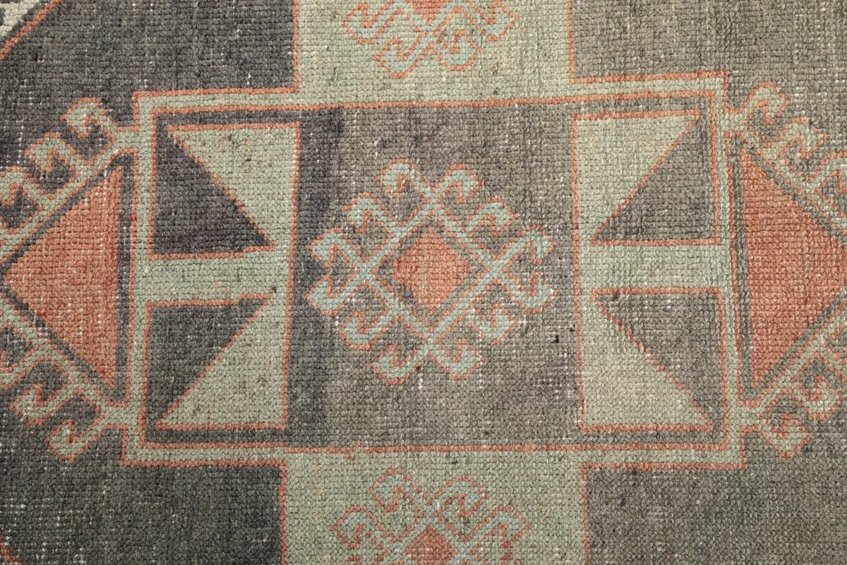 Overhead detail of a complex geometric pattern within the runner's central medallions, showing texture.