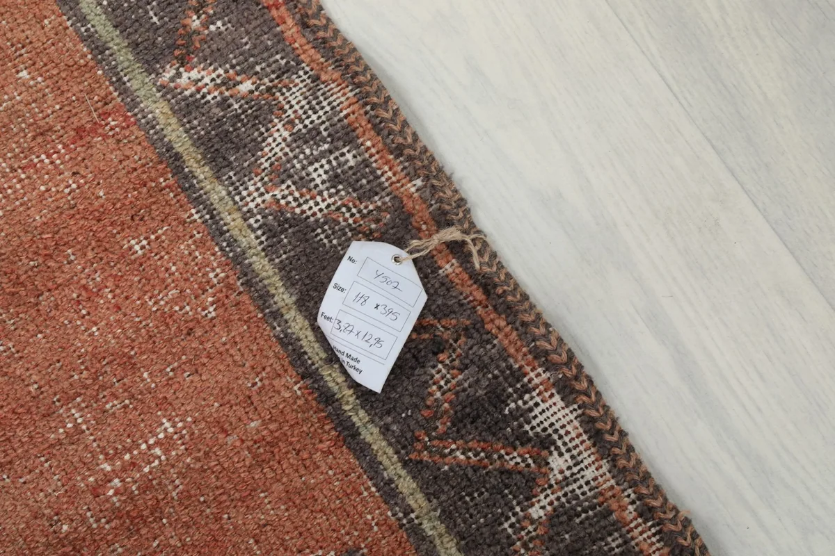 Close-up of the rug's edge with a product tag, illustrating the weave and material.