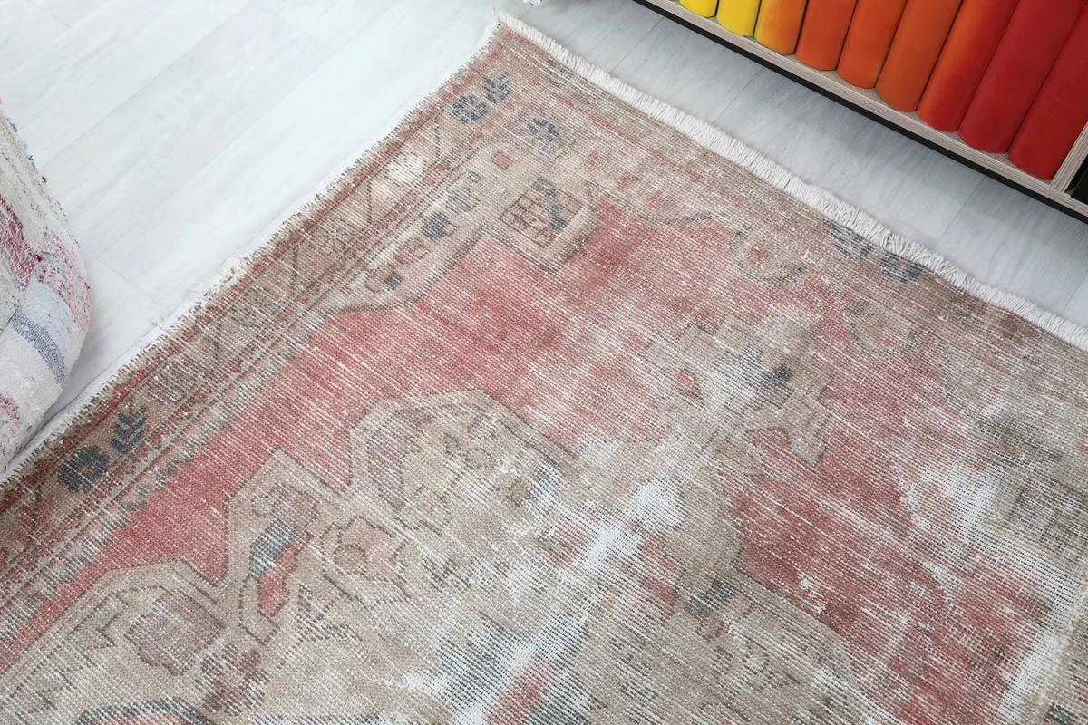 Corner view of the rug, illustrating the low pile and intricate border design