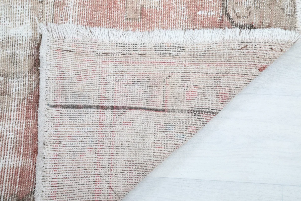 Close-up of the rug's reverse side, showing the tight hand-knotting and fringe detail