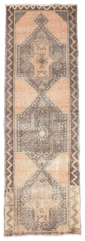 Full overhead view of the vintage Anatolian runner rug with rust and charcoal geometric patterns