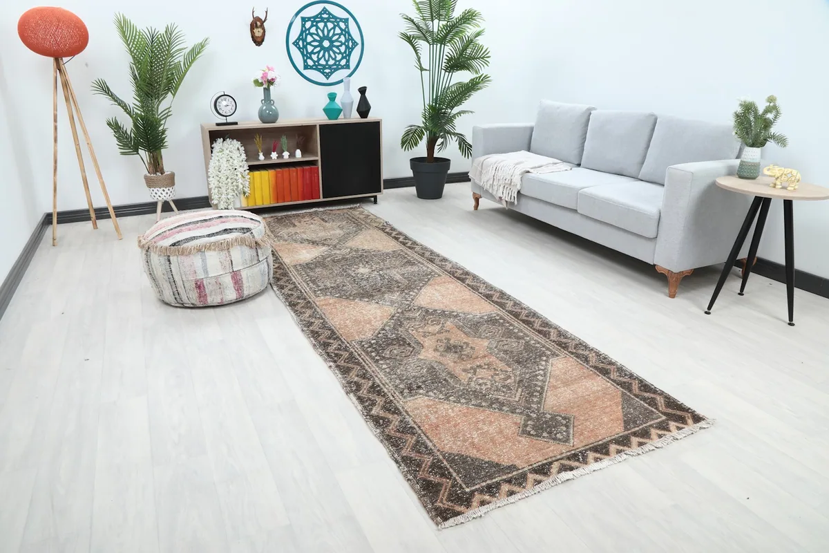Long shot of the rust and charcoal runner rug extending through a contemporary living space