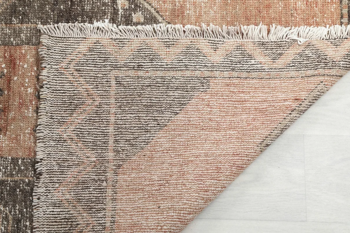 Close-up of the back of the rug, showing the consistent weave and fringe attachment
