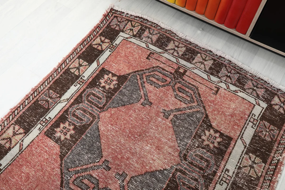 Angled view of the runner rug's upper section, displaying the intricate tribal designs