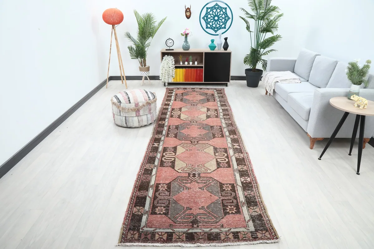 Vintage rose runner rug displayed in a modern hallway with light-colored furniture