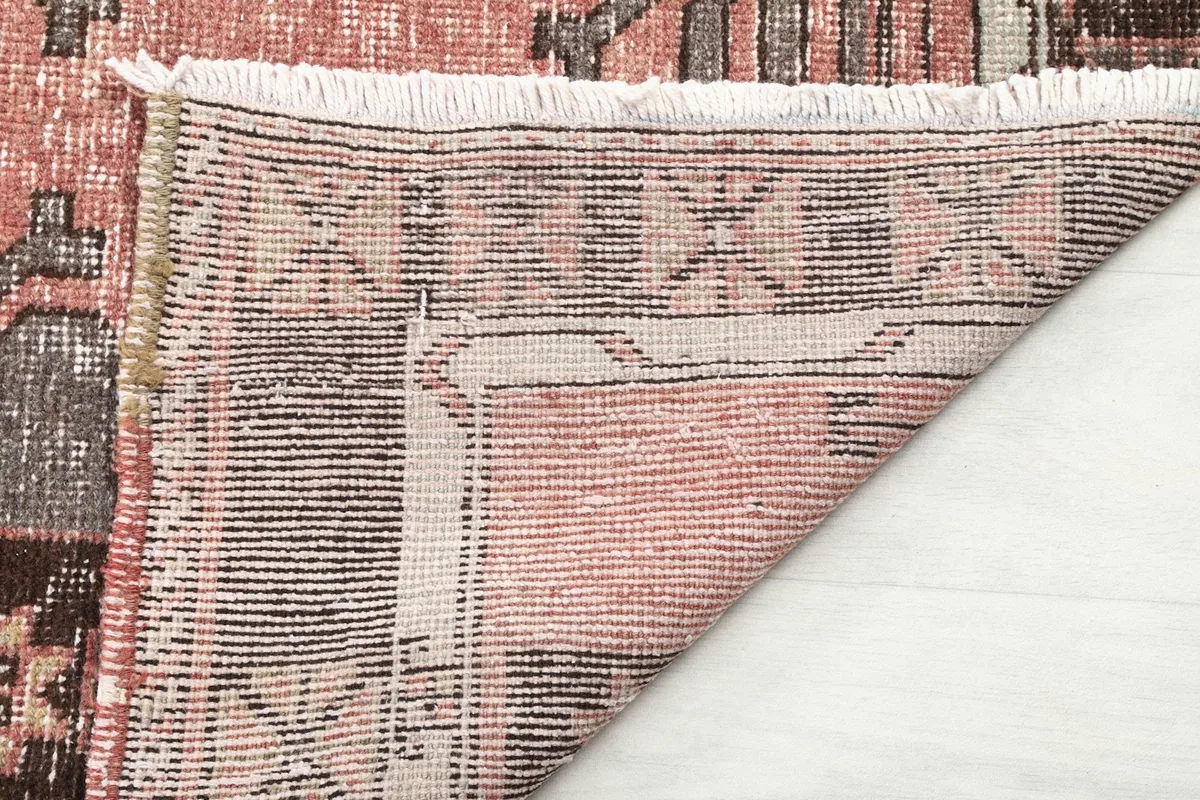 Close-up of the rug's back, showing the cotton foundation and fine hand-knotting