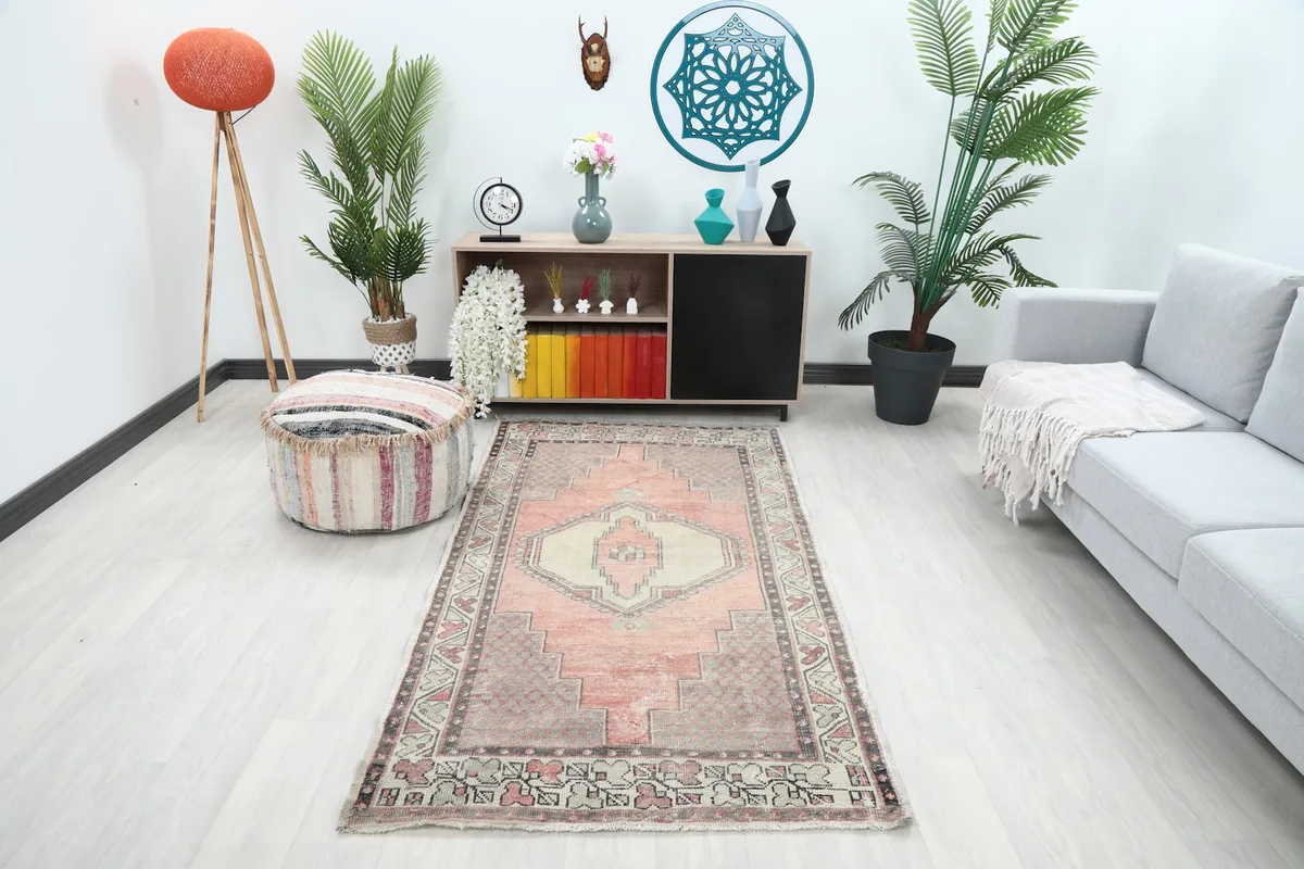 Vintage Anatolian rug displayed in a room setting with light furniture