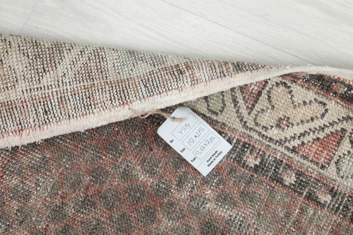 Close-up of the rug's tag with size information and origin