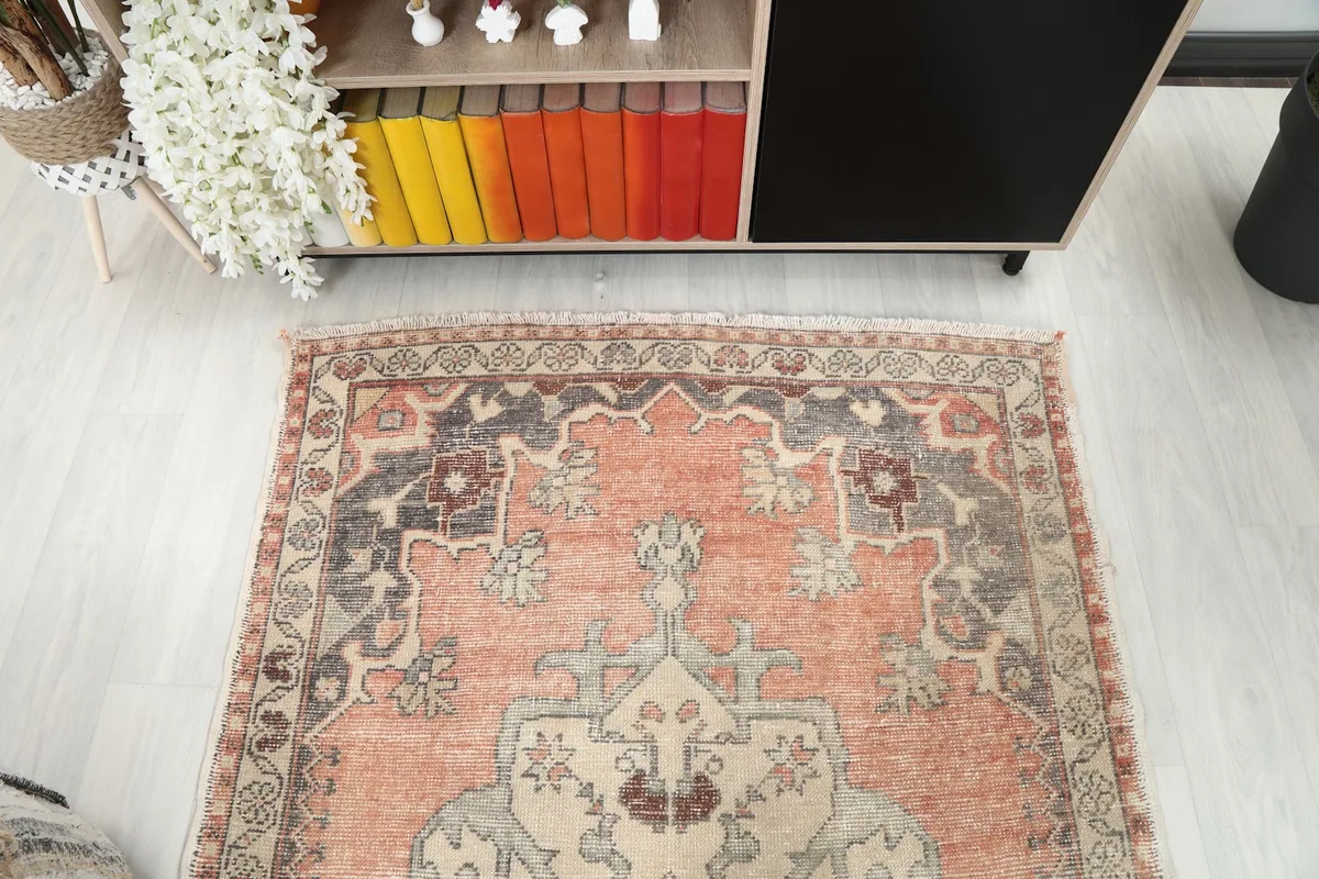 Top-down view of one end of the rug, showing the border and field patterns