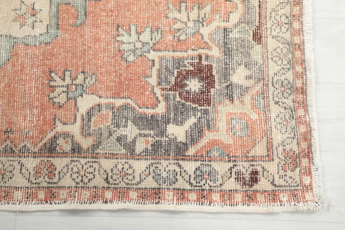 Detailed view of the corner motif and border with gray and brown accents