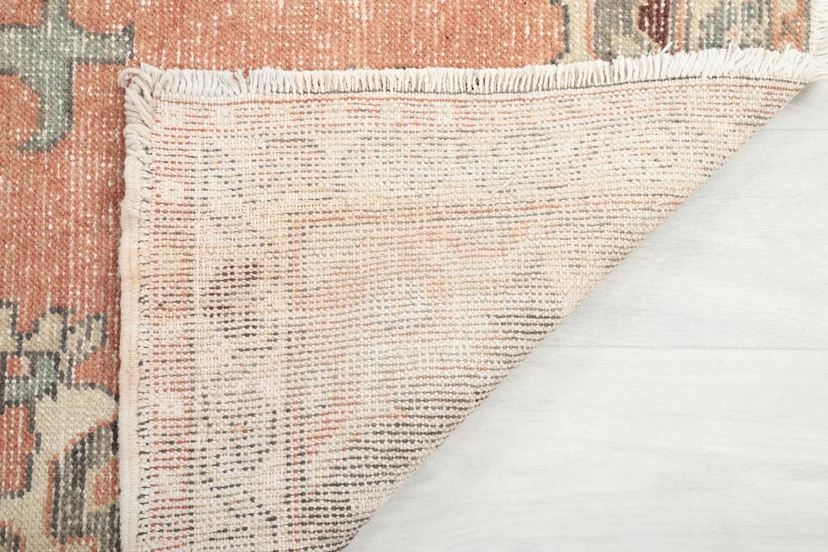 Underside of the rug showing the tight hand-knotting and fringe detail
