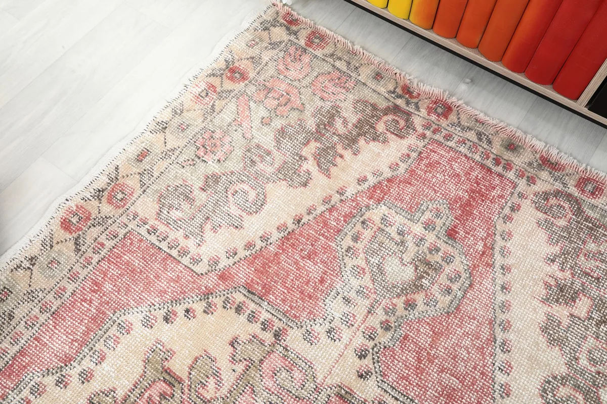 Angled shot of the rug's upper section, showing the border and main field patterns.
