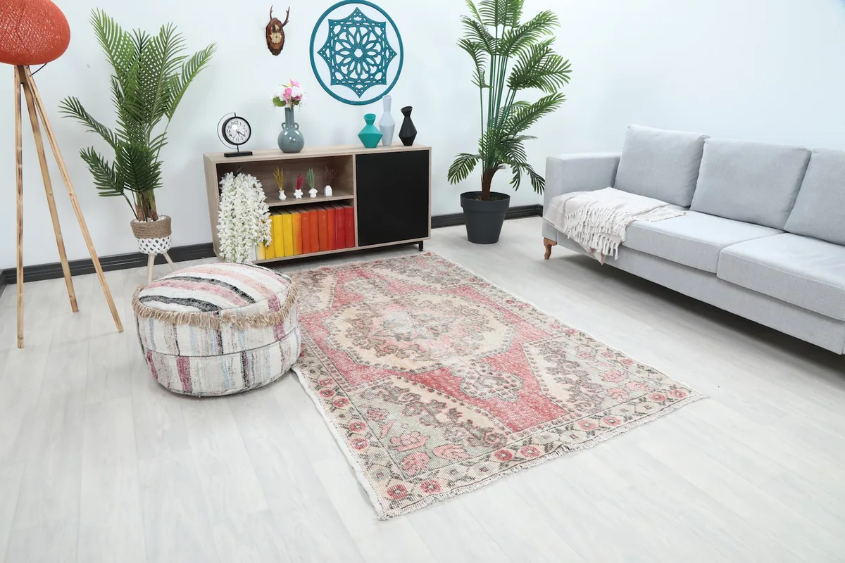 Angled wide shot of the rug in a room, showing its texture and color variation from a different perspective.
