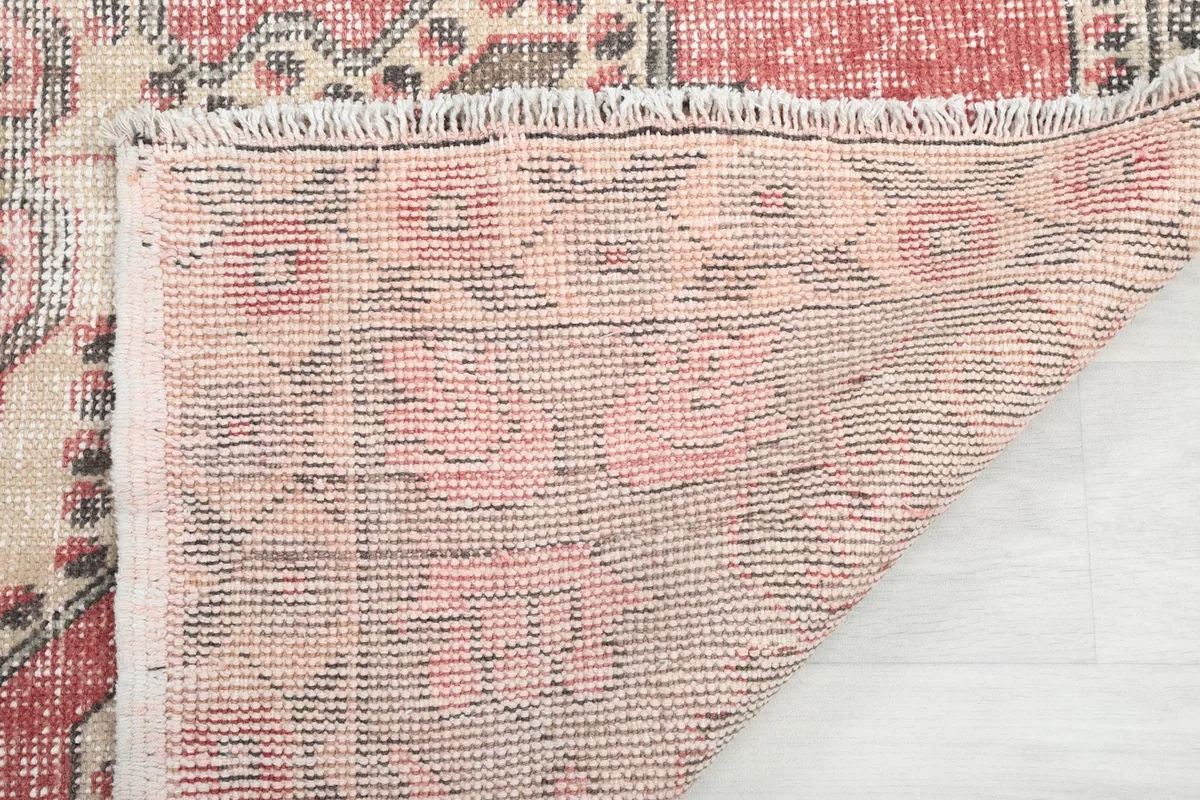 Reverse side of the rug showing the tight hand-knotting and fringe detail.