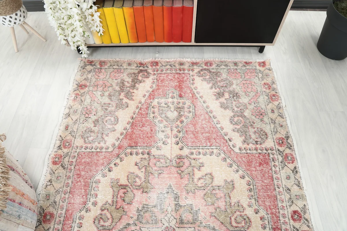 Overhead view of the vintage rug, showing its placement in a room setting with a bookshelf.